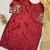 Back view: Embellished maroon ethnic dress with scattered gold motifs and ornate sleeve ends.