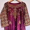 Ornate hand-embroidered lattice sleeve detail on maroon ethnic dress.