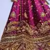 Ornate hand-embroidered lattice sleeve detail on maroon ethnic dress.