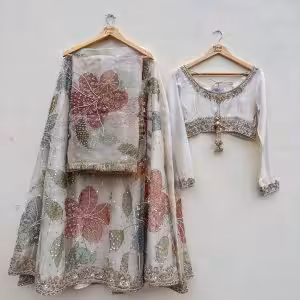 Luxury pastel floral embroidered lehenga set in ivory with blouse and dupatta, CoutureCraze 2025.