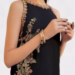 Close-up of black embroidered straight suit with gold floral vine embroidery and sleeveless neckline.