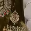 Hand embroidered sleeve detail on olive green velvet suit with resham and zari work