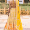 ide view of yellow organza lehenga showing flare and hand-stitched detailing by CoutureCraze