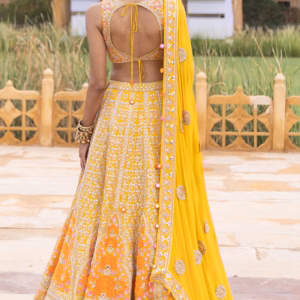ide view of yellow organza lehenga showing flare and hand-stitched detailing by CoutureCraze